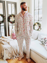 Get cozy in timeless holiday style with our Menโs and Womenโs Holly Jolly Reindeer print. Designed for comfort and classic charm, this two-piece set features a button-down long sleeve top and relaxed-fit pants in a festive pattern that includes bows, reindeer, mistletoes and more. Made from ultra-soft, breathable fabric, itโs perfect for lounging, sleeping, or matching family Christmas mornings.
